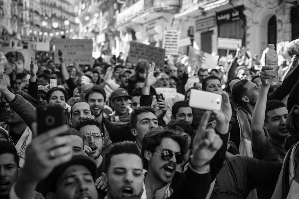 A crowd holding up mobile phones, illustrating how digital audiences participate in public debate