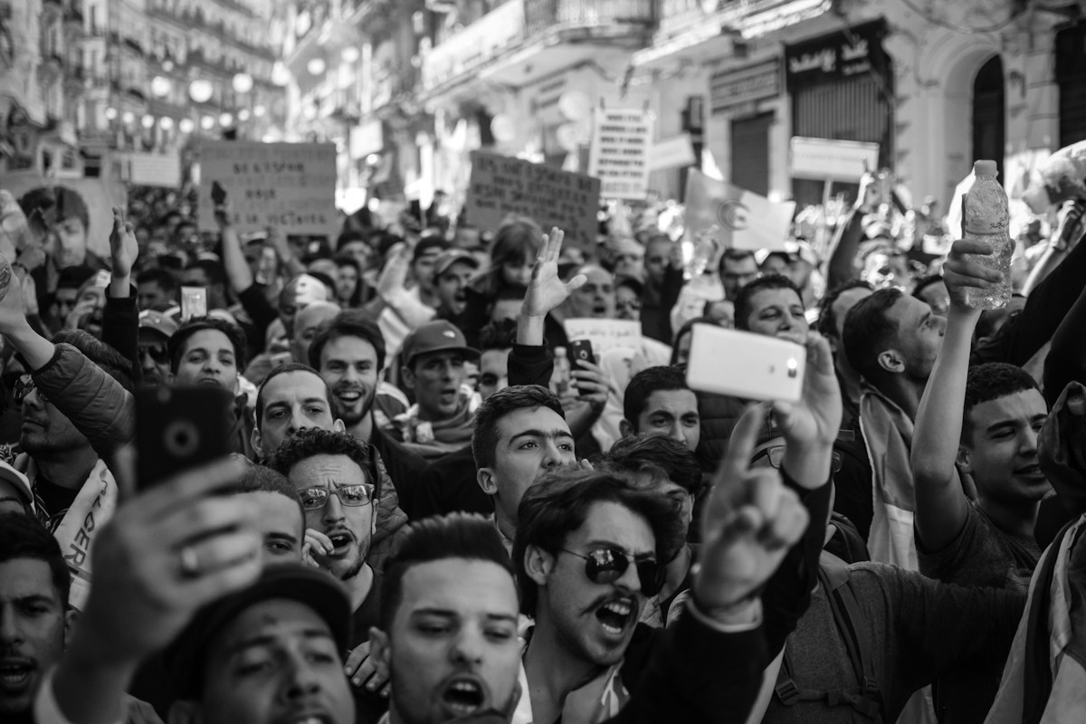 A crowd holding up mobile phones, illustrating how digital audiences participate in public debate
